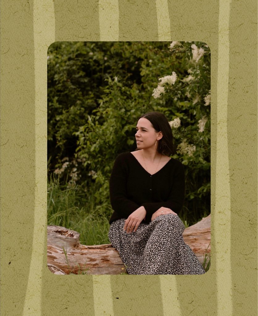 Photo représentant Audrey Voltz, coach professionnelle certifiée, assise sur un tronc d'arbre dans la nature.
